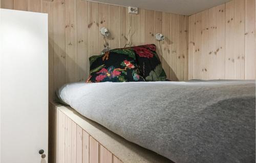 a bed in a room with a wooden wall at Nordseter Sportell 271 in Lillehammer
