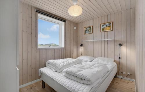 a bedroom with a bed with white sheets and a window at Lovely Home In Faaborg With Wifi in Fåborg