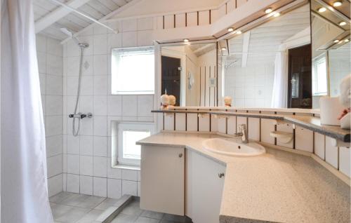a white bathroom with a sink and a mirror at Stunning Home In Ebeltoft With 4 Bedrooms, Private Swimming Pool And Indoor Swimming Pool in Ebeltoft