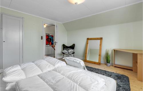 a white living room with a white couch and a mirror at Stunning Home In Østermarie With Wifi in Østermarie