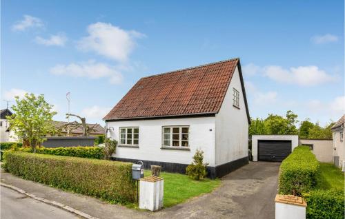 a white house with a brown roof at Stunning Home In Østermarie With Wifi in Østermarie