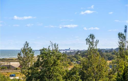 a view of the ocean from a hill with trees at Nice Home In Frederikshavn With Wifi in Frederikshavn