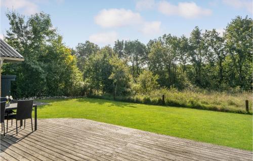 a large yard with a wooden deck and a lawn at Holiday Home Østmarken Toftlund V in Arrild