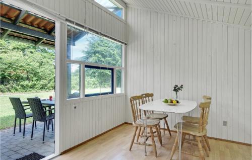 a dining room with a white table and chairs at Gorgeous Home In Hampen With Wifi in Hampen
