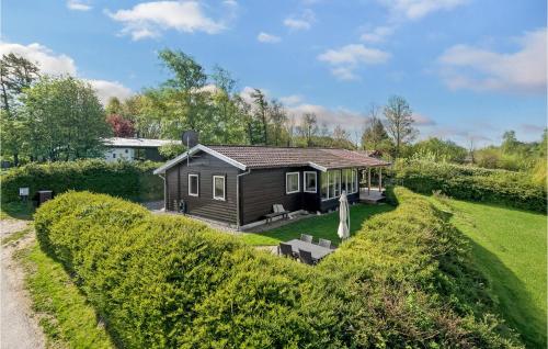 a small house in the middle of a yard at Holiday Home Træløbervej Tranekær Xi in Lokkeby