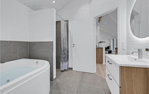 a white bathroom with a tub and a sink at Gorgeous Home In Sjølund With Kitchen in Sjølund