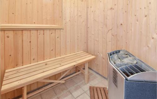 a sauna with a bench and a trash can at Holiday Home Strandparken Otterup Vi in Otterup