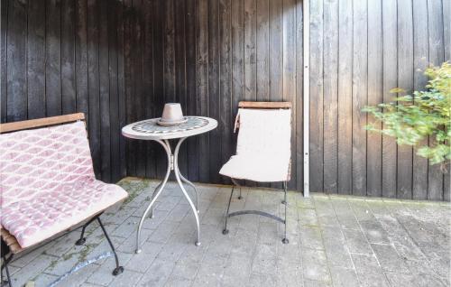 a table and a chair and a table with a hat at Holiday Home Strandparken Otterup Vi in Otterup