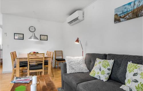 a living room with a gray couch and a table at One-Bedroom Holiday Home In Ribe in Ribe