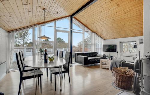a living room with a table and chairs at Holiday Home Gunhildsvej Vestervig Vi in Vestervig