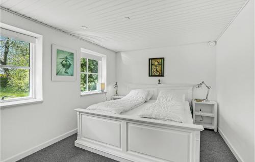 a white bedroom with a bed in a room with a window at 4 Bedroom Amazing Home In Store Heddinge in Store Heddinge