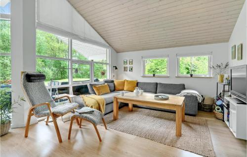 a living room with a couch and a table at 4 Bedroom Cozy Home In Hadsund in Hadsund