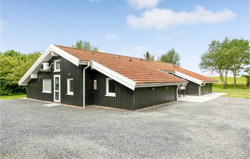 a black house with a red roof at Lovely Home In Sydals With Sauna in Høruphav