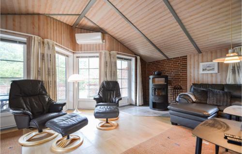 a living room with leather chairs and a couch at Holiday Home Rømø 60 in Rømø