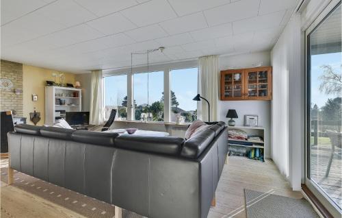 a large leather couch in a living room with a laptop at Lovely Home In Faaborg With Wifi in Faaborg