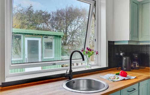 a kitchen counter with a sink and a window at Stunning Home In Hvide Sande With Kitchen in Hvide Sande