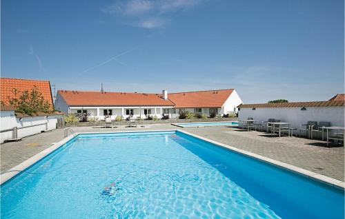 a large blue swimming pool in front of a house at Casa Blanca in Gudhjem