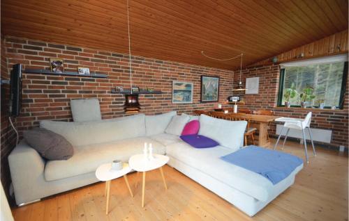 a living room with a couch and a brick wall at Three-Bedroom Holiday Home In Struer in Struer