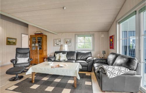 a living room with a couch and a table at 3 Bedroom Stunning Home In Hemmet in Hemmet
