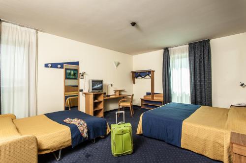 Postel nebo postele na pokoji v ubytování Hotel Mastai