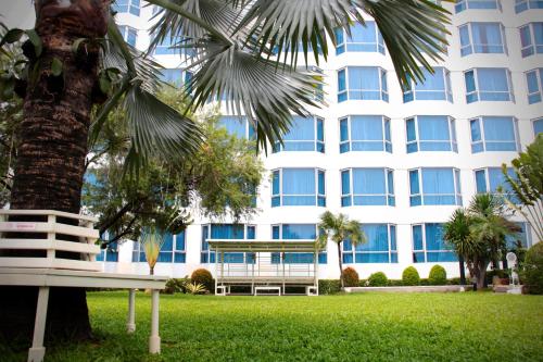a palm tree in front of a building at Millennium Hotel Sirih Jakarta in Jakarta