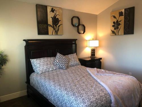a bedroom with a bed with two pillows on it at Cozy and beautiful 3 bedroom house close to lake in Edmonton