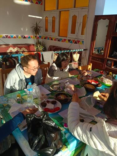 a group of people sitting around a table eating food at Nuba Dool in Aswan