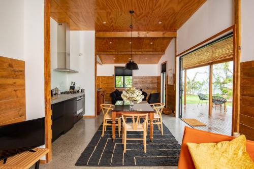a kitchen and dining room with a table and chairs at River Road Retreat in Nelson