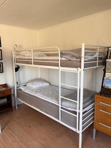 a couple of bunk beds in a room at Grindstugan på Fyrås Gård in Hammerdal