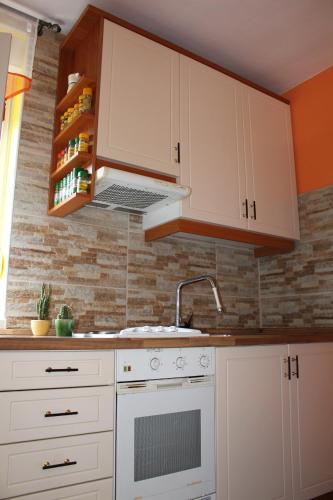 a kitchen with white cabinets and a sink at Rooms4Young in Ljubljana