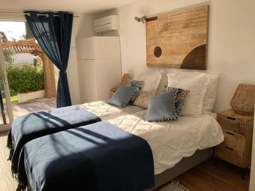 a bedroom with a bed with pillows and a window at Bed,Kitchen and Swimming Pool Villa Esterel in Saint-Raphaël