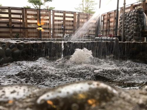 a stream of water shooting out of a fountain at XingYe B&B in Checheng