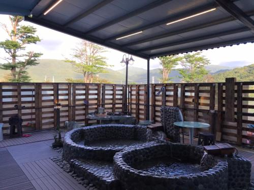 a patio with a fire pit on a deck at XingYe B&B in Checheng