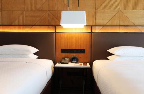 Ένα ή περισσότερα κρεβάτια σε δωμάτιο στο Four Points by Sheraton Yiyang