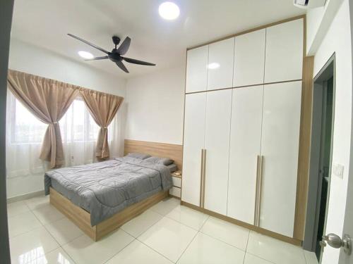 a bedroom with a bed and a ceiling fan at Eroz Traders Gargen c180 cheras in Cheras