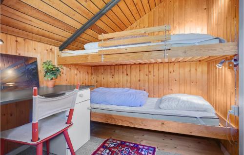 a room with two bunk beds and a desk at 2 Bedroom Cozy Home In Havndal in Sødring