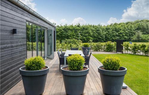 a patio with a table and chairs on a wooden deck at Lovely Home In Toftlund With Wifi in Toftlund
