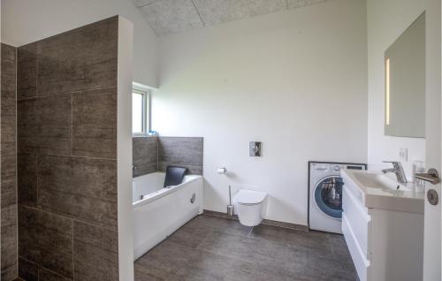 a bathroom with a sink and a washing machine at Lovely Home In Toftlund With Wifi in Toftlund
