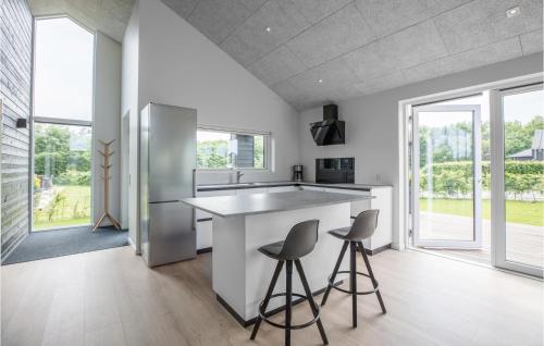 a kitchen with a large island and two stools at Lovely Home In Toftlund With Wifi in Toftlund