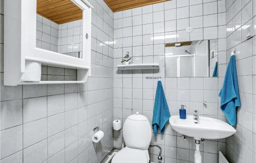 a white bathroom with a toilet and a sink at Amazing Home In Hjslev With Kitchen in Højslev