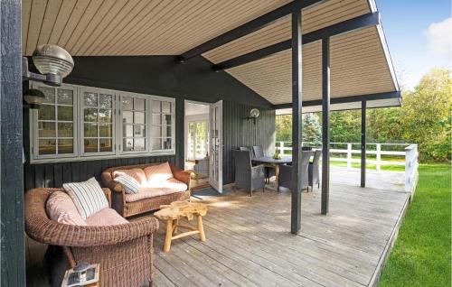 a patio with couches and a table on a deck at Gorgeous Home In Vejby With Wifi in Vejby