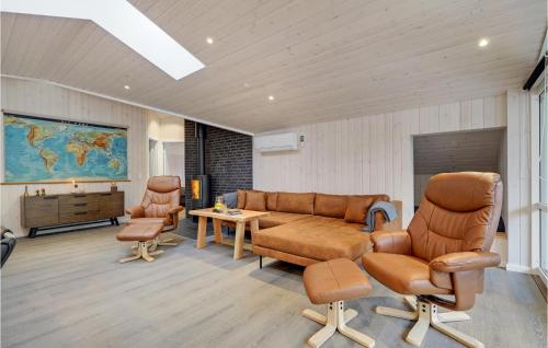 a waiting room with a couch and chairs and a table at Awesome Home In Blåvand With Sauna in Blåvand