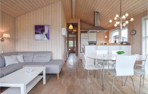 a living room with a couch and a table at Søhus in Fæbæk