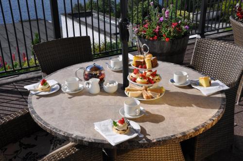 a table with food on it on a balcony at Beech Hill Hotel & Spa in Windermere