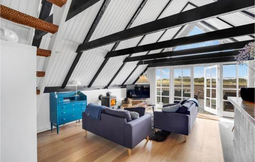 a living room with two chairs and a table at Holiday Home Havklitvej Ringkøbing Vi in Ringkøbing
