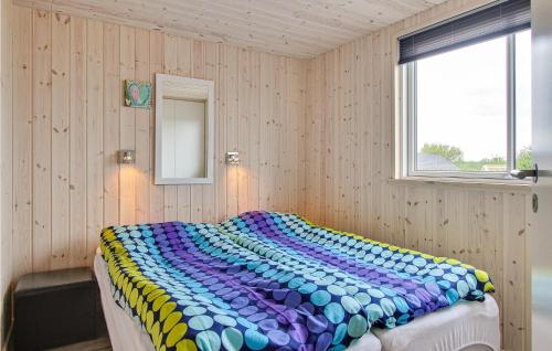a bedroom with a bed with a colorful blanket on it at Gorgeous Home In Bogense With Wifi in Bogense
