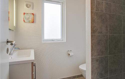 a bathroom with a sink and a toilet and a window at Gorgeous Home In Bogense With Wifi in Bogense
