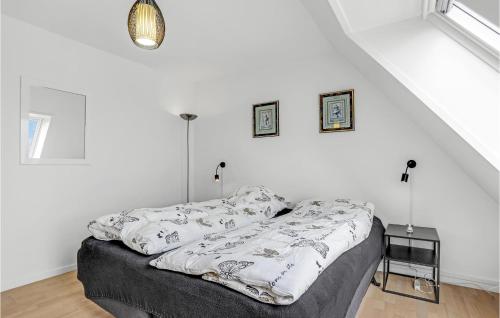 a bed in a room with white walls at Lovely Apartment In Gudhjem With Wifi in Gudhjem
