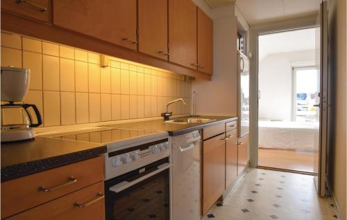 a kitchen with a sink and a stove top oven at Two-Bedroom Apartment In Rudkobing in Rudkøbing