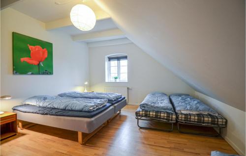 two beds in a room with a staircase at Sjørupgaard in Nimtofte